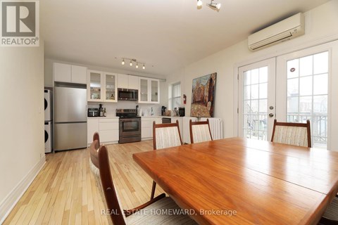 A well-lit kitchen with a wooden dining table and chairs.
