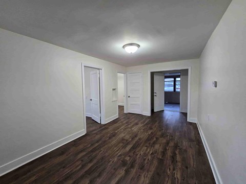 A room with wooden floors and white walls.