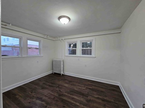 A room with a window and a radiator on the wall.