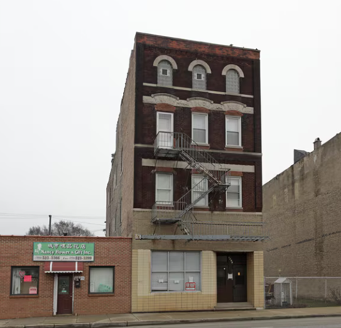 A brick building with a sign that says "Happy Birthday Gift Inc."