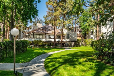 A house with a lawn and trees in front of it.