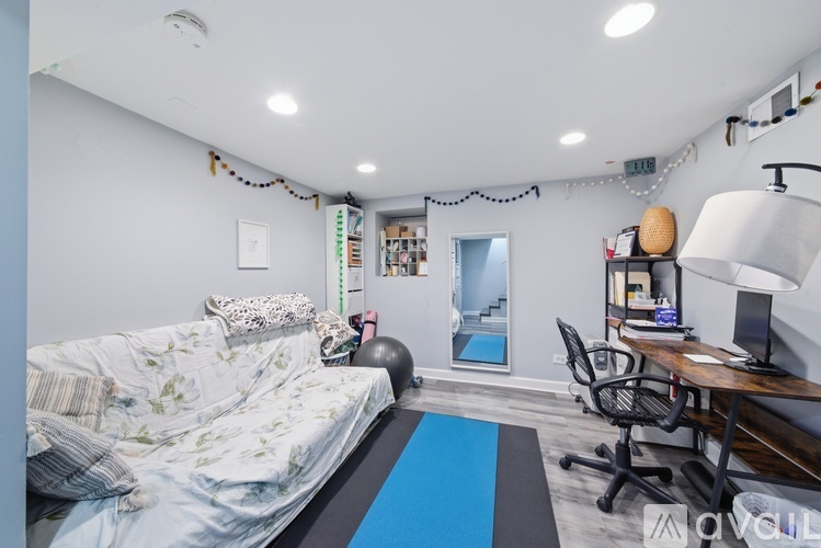 A living room with a couch, coffee table, and a door with a sign on it.