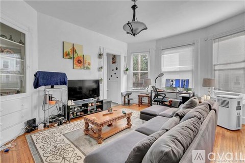 A living room with a grey sofa and a wooden coffee table.