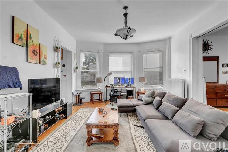 A living room with a grey couch and a coffee table.