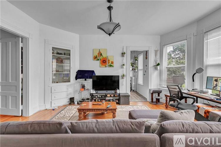 A living room with a grey couch and a television.