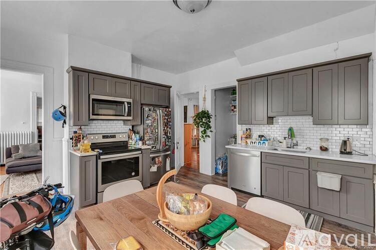 A kitchen with a table and chairs in the middle of the room.