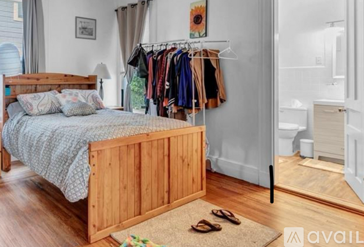 A bedroom with a wooden bed and a clothing rack.