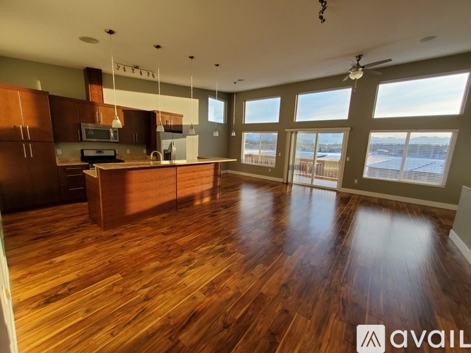 A spacious kitchen with wooden floors and a large island.