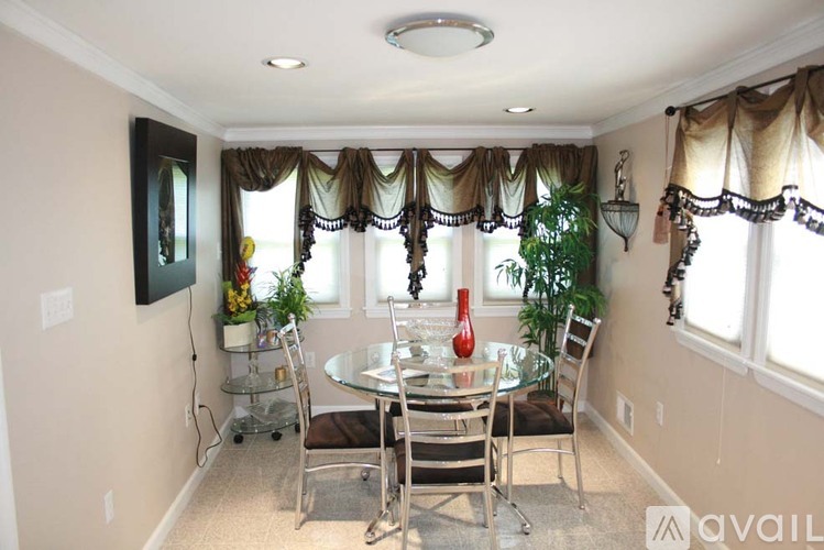 A dining room with a glass table and chairs.
