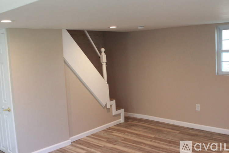 A room with a staircase leading to the upper floor.