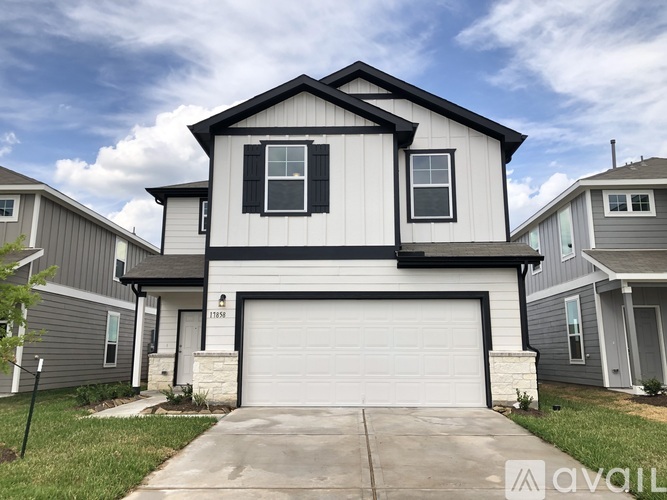 A two-story house with a garage is for sale.