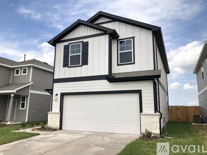 A two-story house with a garage is for sale.