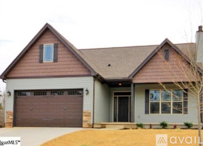 A two-story house with a garage is for sale.