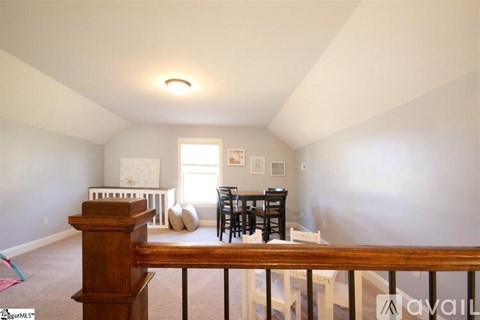 A living room with a dining table and chairs.