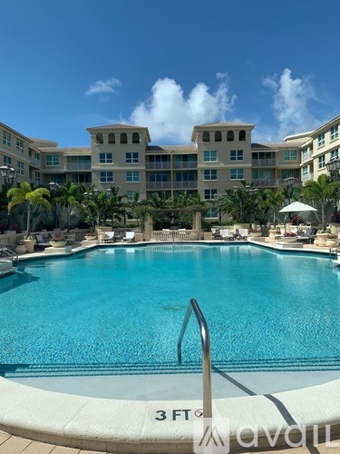 A large swimming pool in front of a resort.