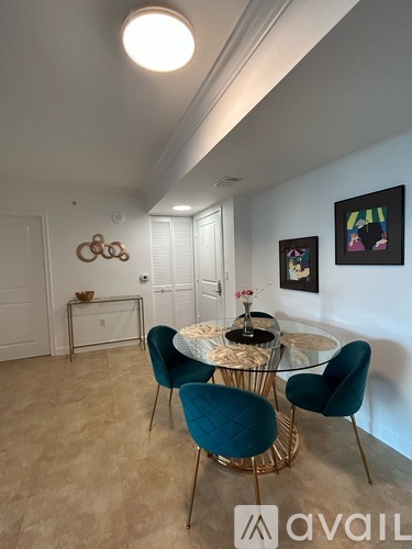 A dining room with a glass table and chairs.