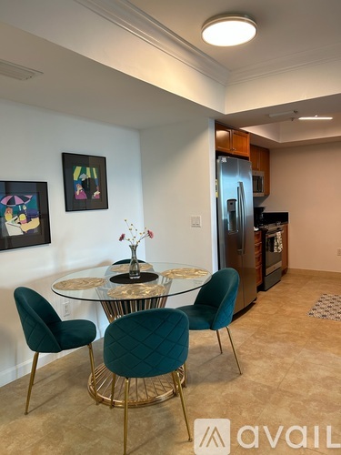 A kitchen with a glass table and chairs.