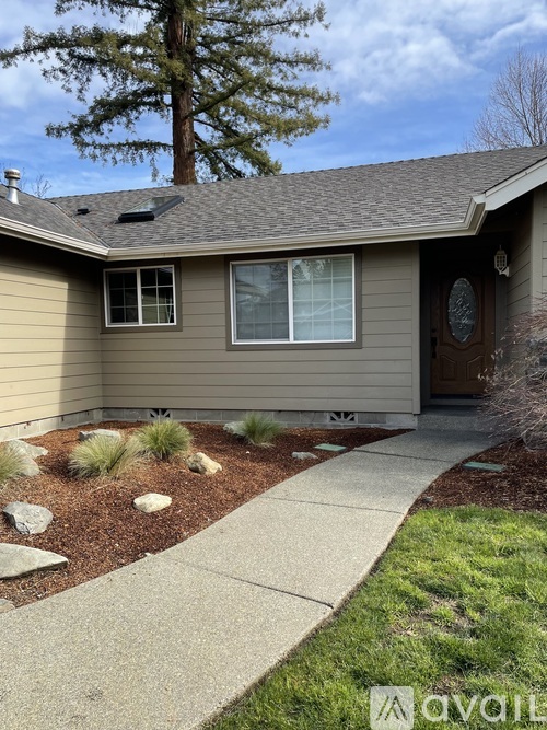 A house with a brown door and a grey roof.