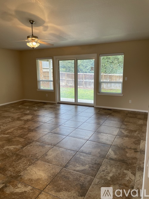 A room with tiled flooring and a ceiling fan.