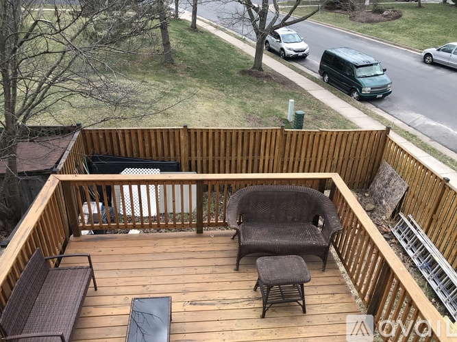 A wooden deck with a chair and a table.