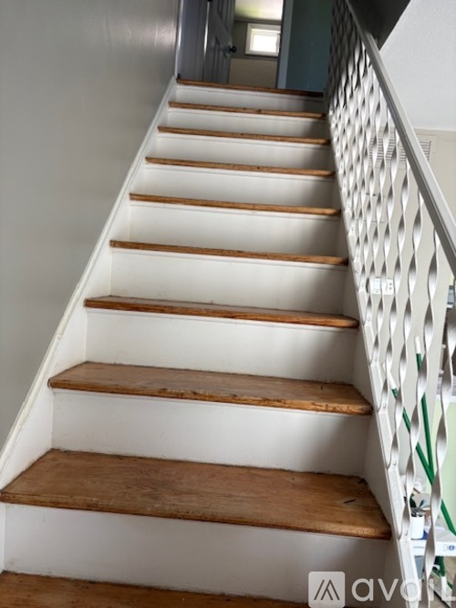 A staircase with wooden steps and a metal railing.
