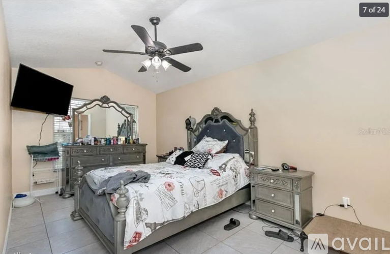 A bedroom with a bed, dresser, and mirror.