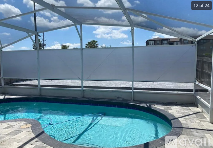 A pool under a white canopy on a sunny day.