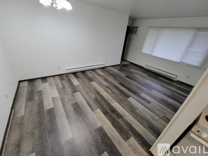 A room with a wooden floor and white walls.