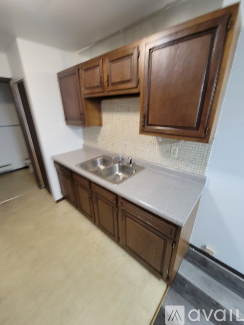 A kitchen with brown cabinets and a white countertop.