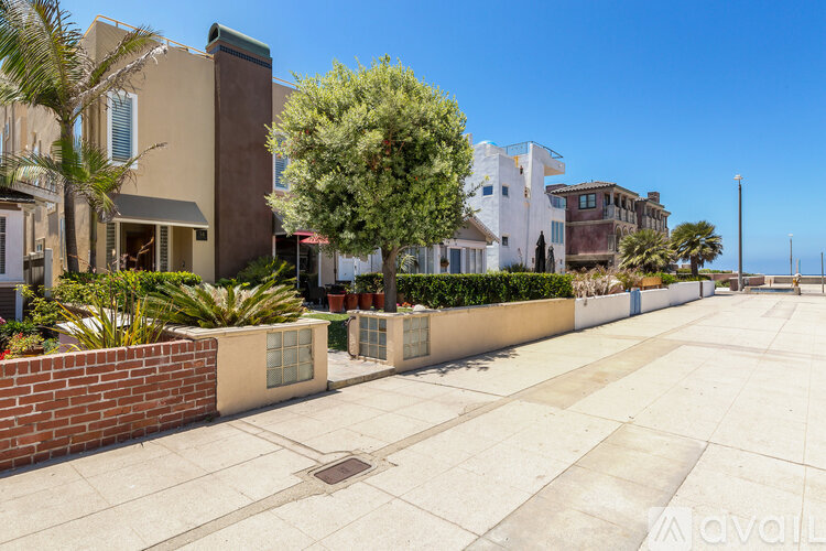 A row of houses with a clear blue sky above them.