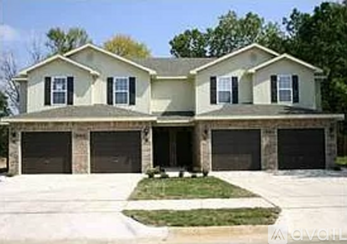 A two-story house with a garage on the lower level.