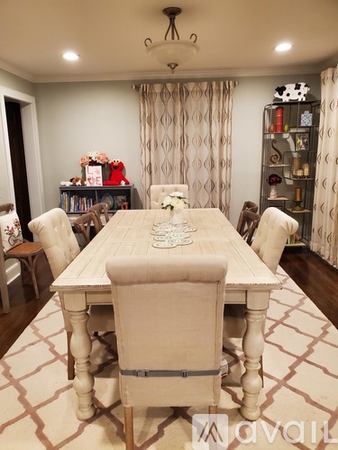 A dining room with a table set for four.