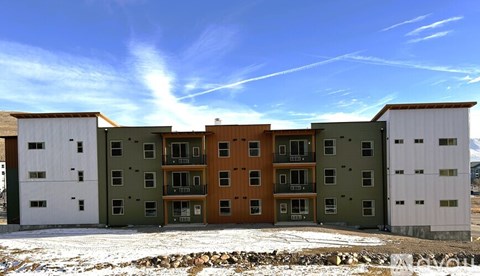 A row of multi-story buildings with balconies and windows.