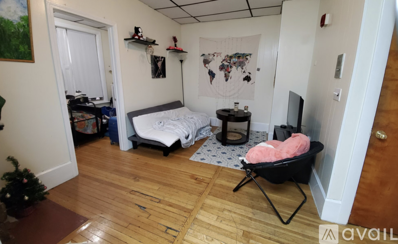 A room with a bed, a chair, and a TV.