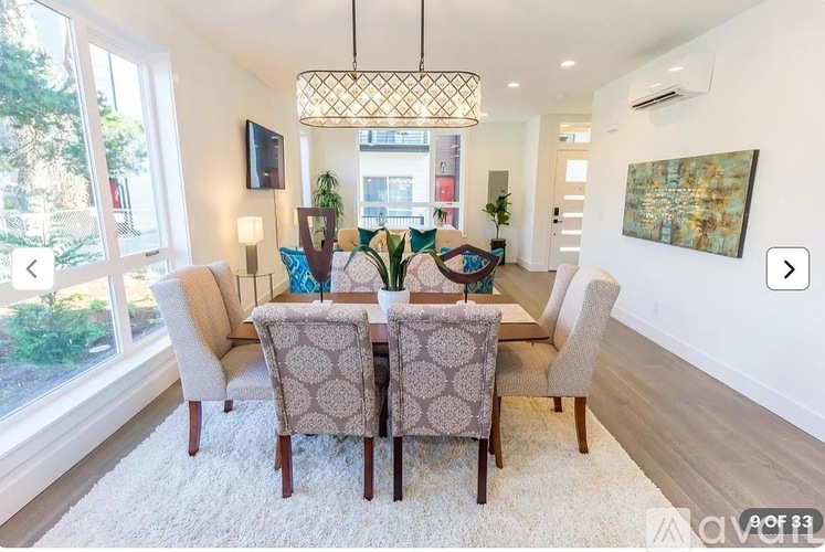 A dining room with a table set for six.