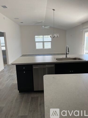 A kitchen with a sink and a window.