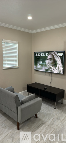 A living room with a grey couch and a black coffee table.