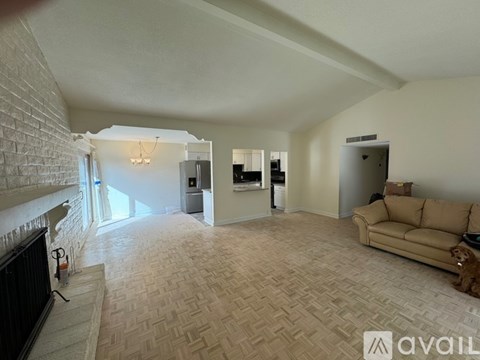 A living room with a couch and a fireplace.
