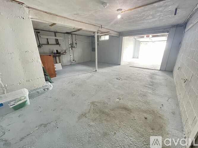 A spacious garage with a concrete floor and white walls.