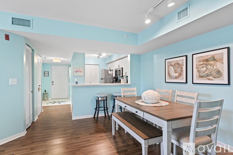 A dining room with a wooden table and chairs.