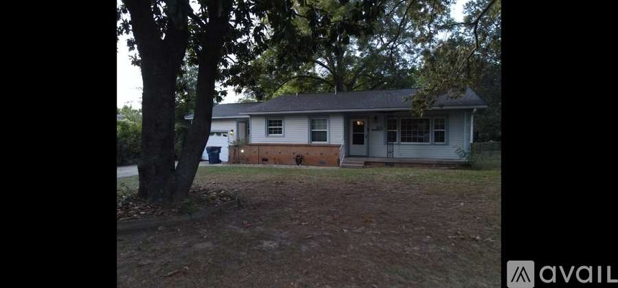 A house with a tree in front of it.