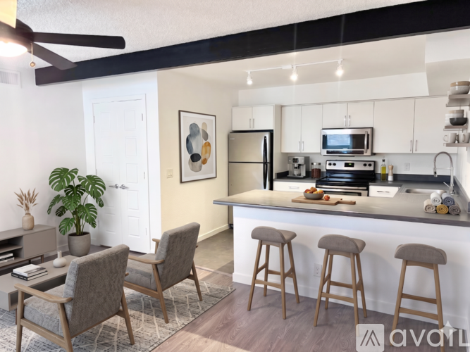 A kitchen with a bar area and a dining table.