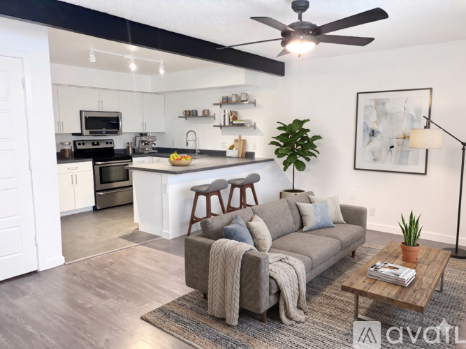 A living room with a grey couch and a coffee table.