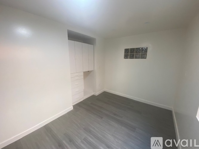 A room with grey flooring and white walls.