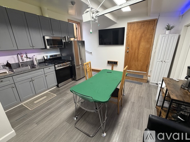 A kitchen with a table and chairs in the middle of the room.
