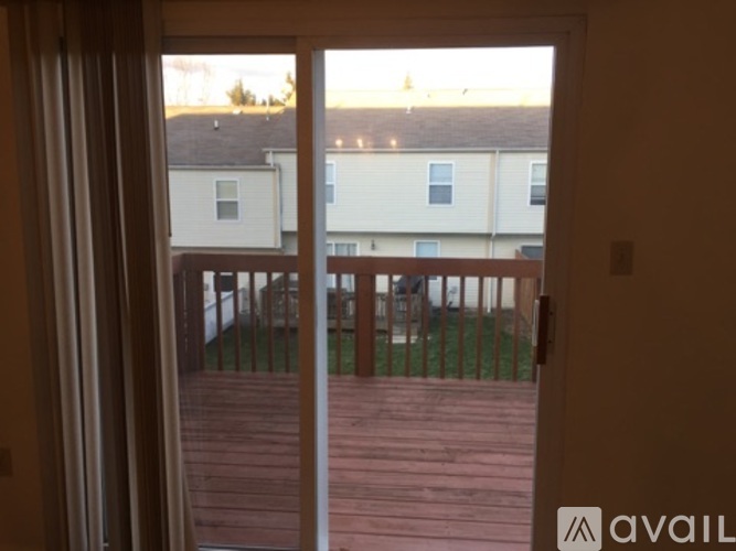 A balcony with a view of apartment buildings.