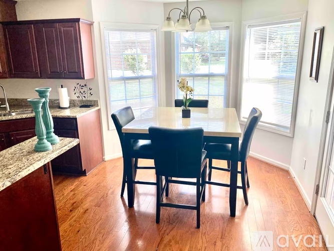 A kitchen with a table and chairs in the middle of the room.