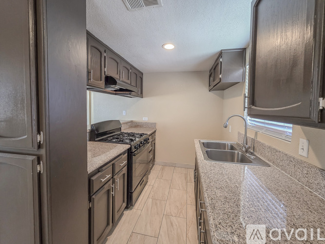 A kitchen with granite countertops and stainless steel appliances.