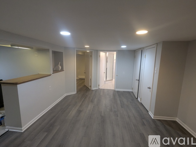 A room with a wooden floor and white walls.