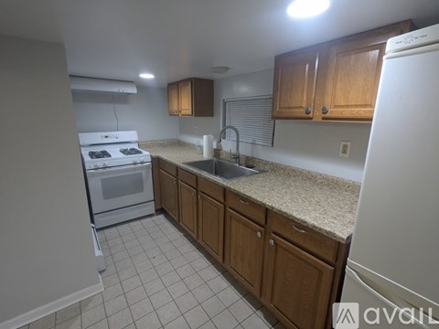 A kitchen with a white oven and sink.